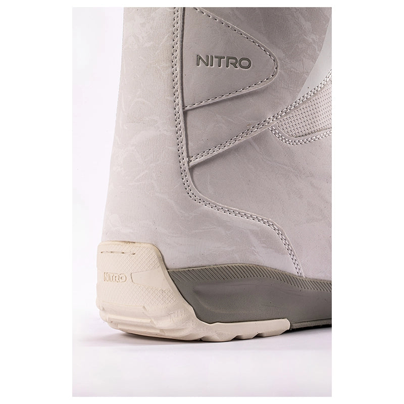 Close-up of the heel and side of a light gray Nitro snowboard boot, showing the textured upper, stitched details, and sole.