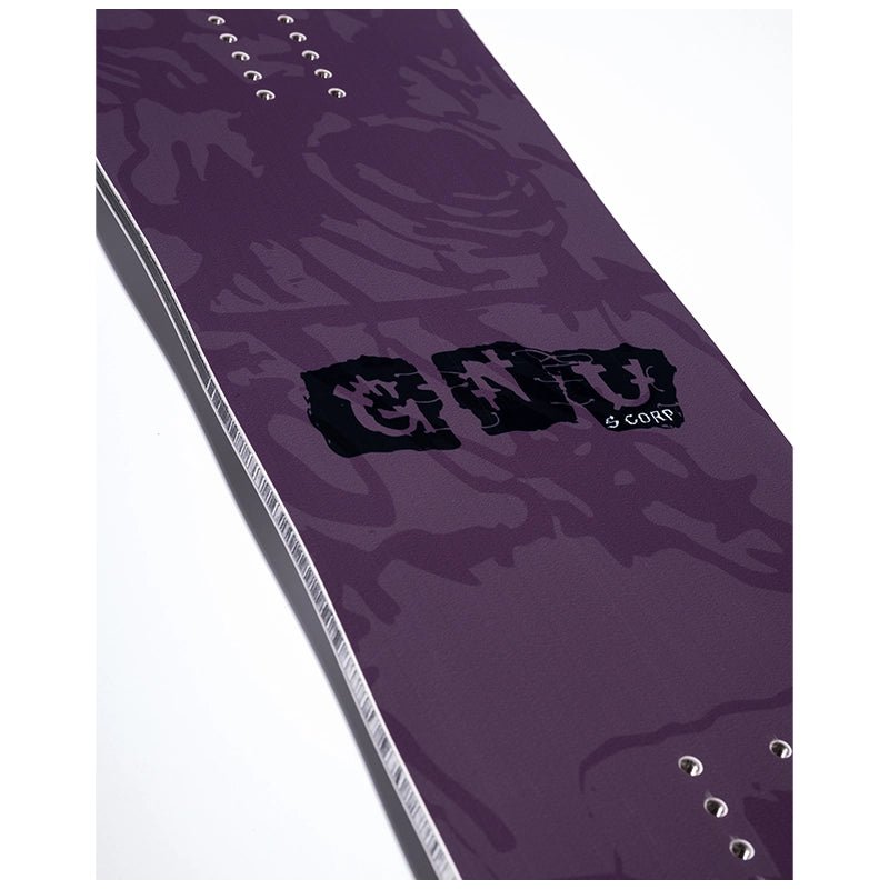 A close-up of a purple snowboard base featuring a dark abstract graphic pattern, a black 'G128' logo, and silver metal binding eyelets along the edge, set against a plain white background.
