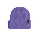 A purple ribbed knit beanie hat with a folded cuff, featuring a small black brand tag on the side, set against a plain white background.