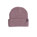 A pink and black checkered knit beanie hat with a folded cuff and a small black brand tag on the side, shown against a plain white background.