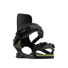 A single snowboard binding shown on a plain white background. The binding is primarily black with textured black straps, a light olive green baseplate, and small yellow-green speckles, plus small purple accents on the adjustment dials.