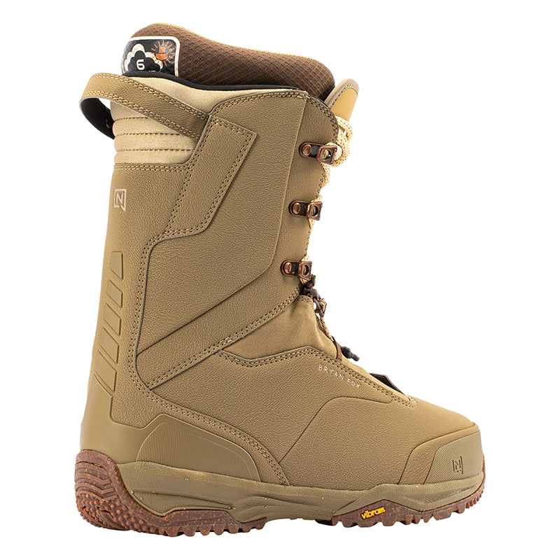 A single high-top snowboard boot in tan and brown, shown from a three-quarters angle on a plain white background. The boot features a tan upper with brown laces, brown pull tabs, and a brown Vibram sole.