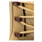 Close-up of a beige textured leather shoe with beige braided laces threaded through dark brown metal eyelets branded with 'MISO'.