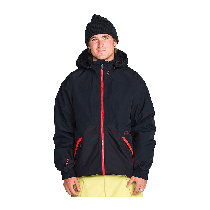 A man wearing a black hooded jacket with bright red zipper accents and a black knit beanie, standing against a plain white background.